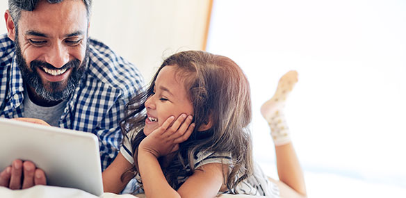 Father and daughter using tablet